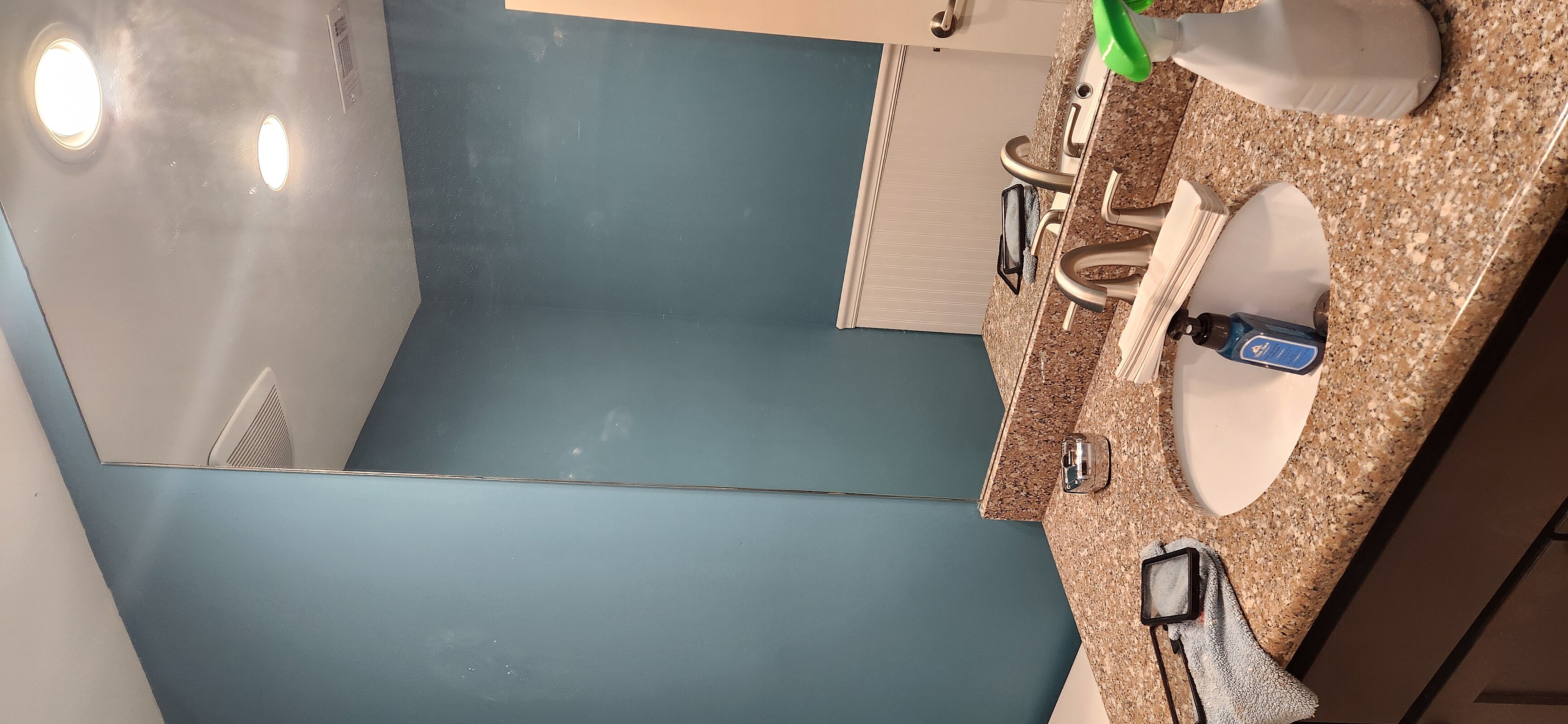 Outdated bathroom vanity and light fixture prior to repair