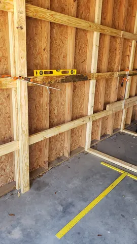 Custom wooden shelf assembly in progress for residential garage setup