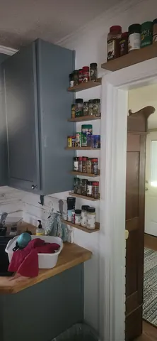 Clean backsplash and aligned cabinet doors in finished 1942 kitchen restoration