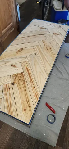 Applying rich wood stain to highlight natural grain patterns